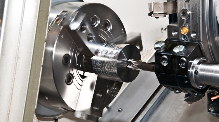 A CNC Lathe working on a spinning piece of metal