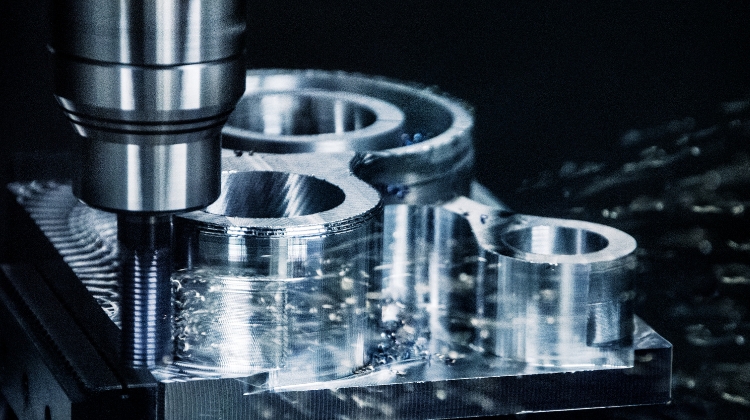 A CNC Mill working on a flat piece of metal