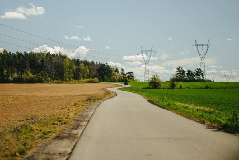 Rural open land with a path to a CNC Shop down the middle between two fields