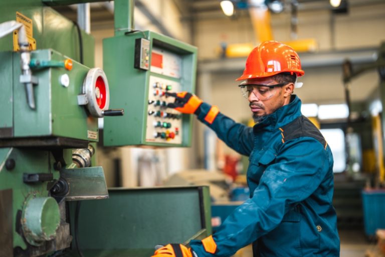 Man working on CNC machine in a high retention CNC shop